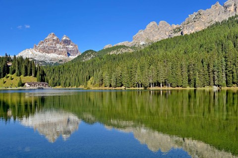Three Peaks of Lavaredo southern walls water reflection in Lake Misurina