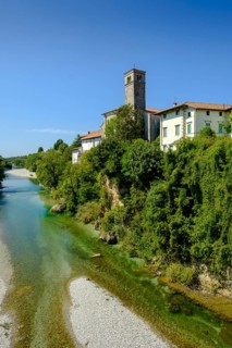 View over the river Natisone to the Campanile of the cathedral Santa Maria Assunta and the old town