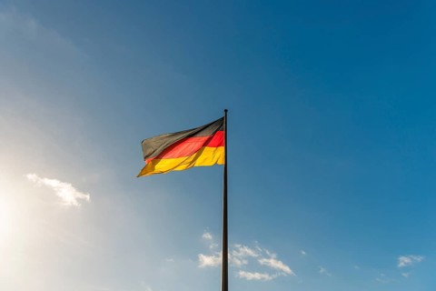 German flag in front of blue sky