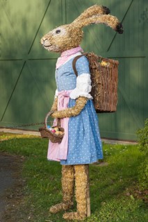 Easter bunny as straw doll with egg basket