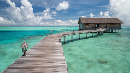 Wooden hut on stilts in lagoon