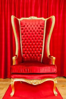 Red royal throne and red curtain behind