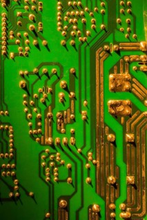 Green and gold computer circuit board close-up