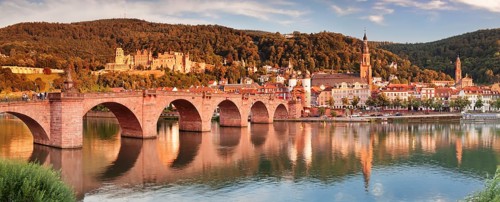 View of Karl Theodor Bridge and Gate over the Neckar River with castle in Heidelberg