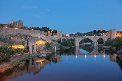 San Juan de los Reyes Church and Puente de San Martin bridge reflected in the Tajo River
