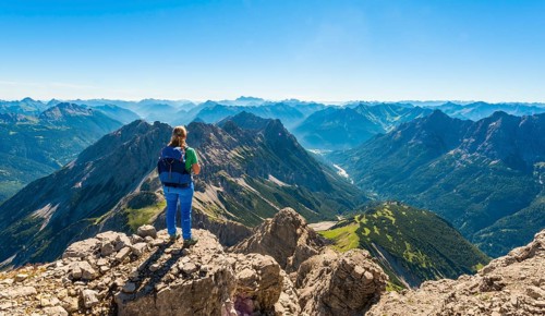 Hiker with views of mountains and Alps