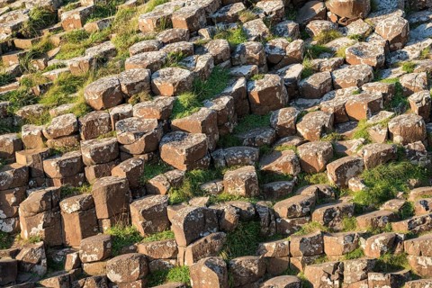 Hexagonal basalt columns towering from the ground at Giant's Causeway