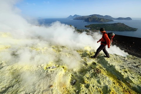 Hiker on the Gran Cratere walks through sulphur fumaroles