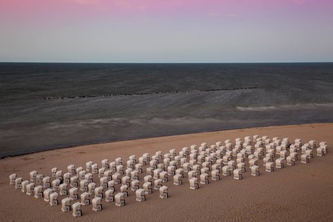 White beach chairs on the beach at twilight