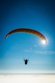 Paraglider over cloud cover