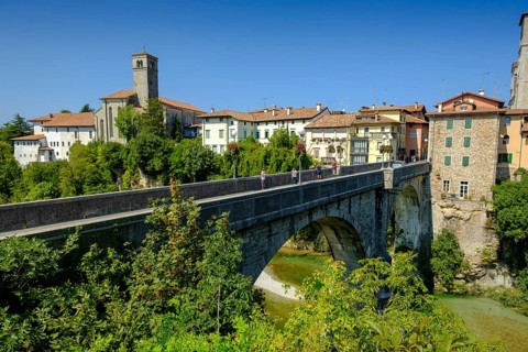 View over the river Natisone to the Campanile of the cathedral Santa Maria Assunta and the old town