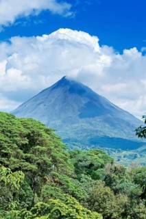 Arenal volcano behind tropical forest
