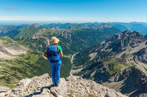 Hiker with views of mountains and Alps