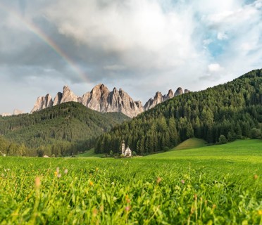 Rainbow in front of the church St. Johann in Ranui