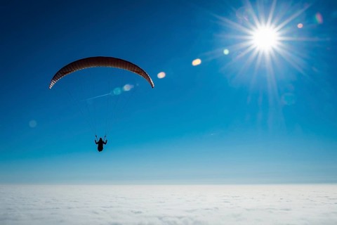 Paraglider over closed cloud cover