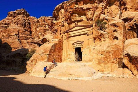 Hikers at rock-church in Little Petra