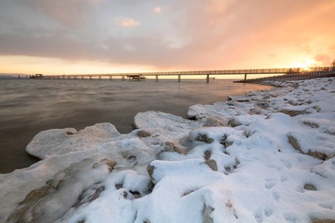 Sunrise with ice and snow on the shore of Lake Constance