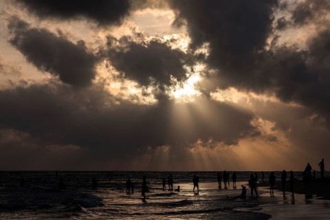 People in backlight on beach