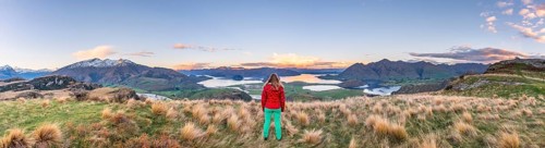 Hiker overlooking Lake Wanaka and mountains