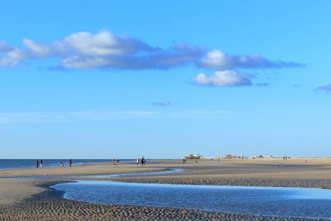 Sandy beach with walkers