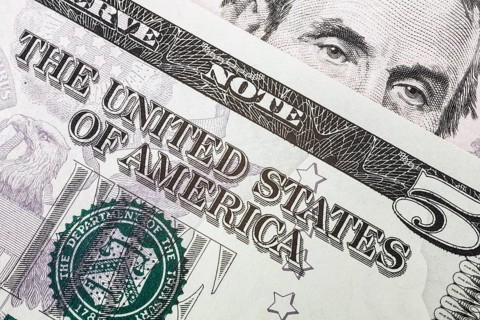 US five dollar bill and portrait of Abraham Lincoln