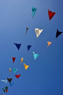 Colorful pennant against a blue sky at a festival