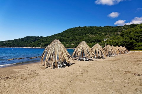 Sunshades at the sand beach at Saplunara