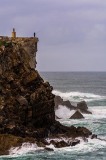 Cliff fisher at steep coast