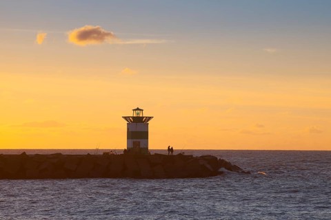 Small lighthouse at harbor entrance