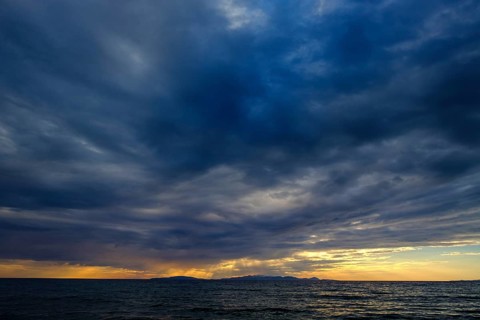 Thunderclouds at sunset on the beach