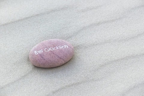 Be Happy inscribed in small stone
