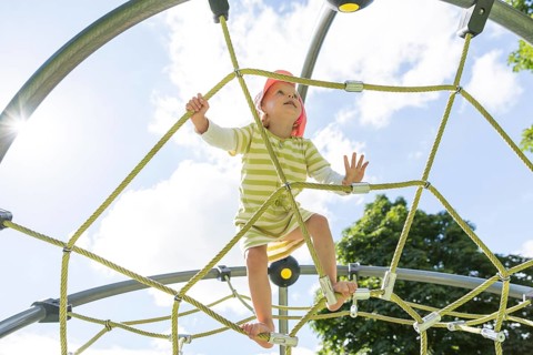 Toddler on climbing frame at a playground