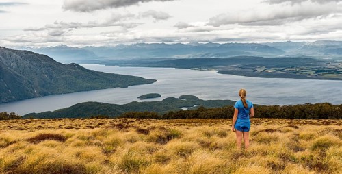 Female hiker looking at lake Te Anau and Southfiord