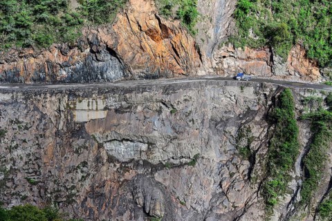 Narrow street in cliff with trucks