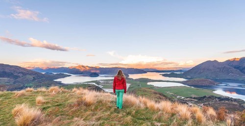 Hiker overlooking Lake Wanaka and mountains