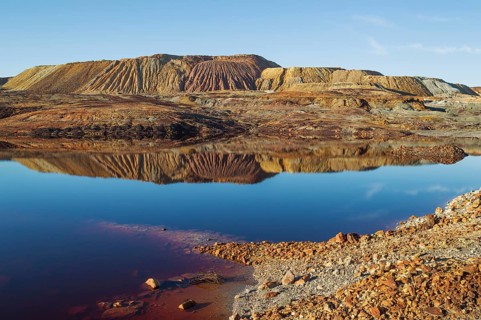 Mineral-rich ground and rocks with rainwater pool at Rio Tinto mines