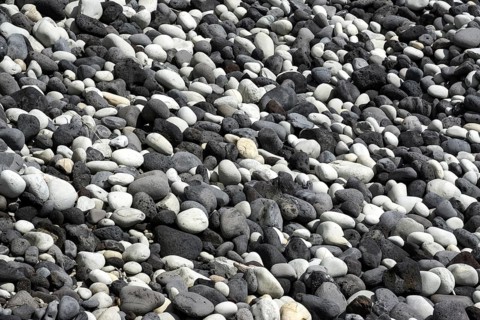Round cut lava stones on the beach