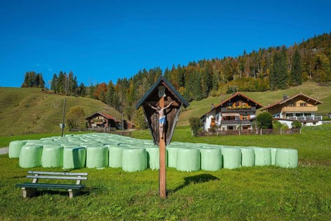 Silo bales in front of farmhouses