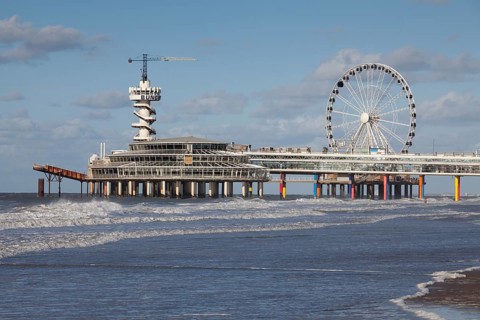 Pier with bungee jumping tower and Ferris wheel