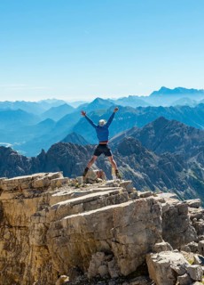 Hiker stretching arms in the air