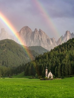 Rainbow in front of the church St. Johann in Ranui