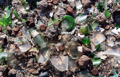 Broken glass and metal parts at a dump