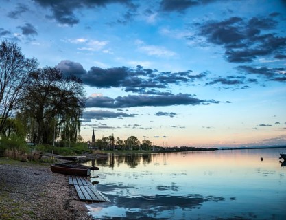 Rowboats by the lake at sunset
