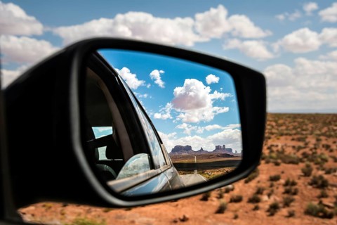 Look into the rear-view mirror of a car
