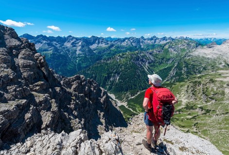 Walker overlooks mountains and Alps
