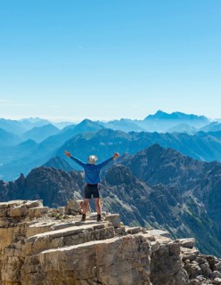 Hiker stretching arms in the air