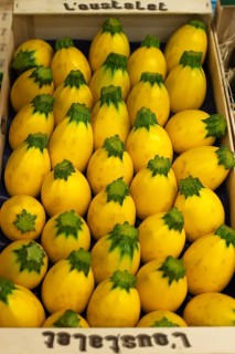 Vegetable crate with yellow eggplant at a market
