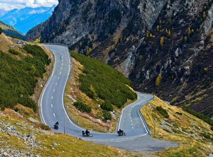 Motorcycles in a hairpin curve on mountain road