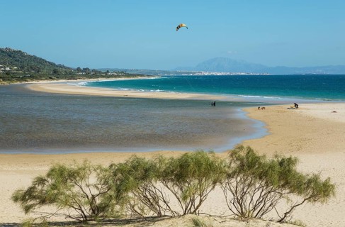 Sandy beach with hang glider at Bay of Valdevaqueros