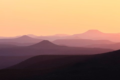 Staggered mountains at sunset
